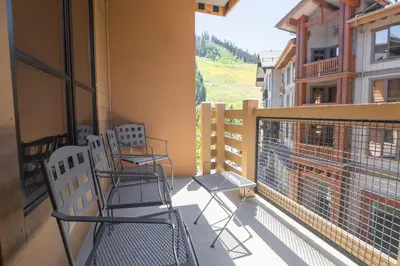two chairs on the balcony of a building at The Village at Palisades Tahoe in Olympic Valley