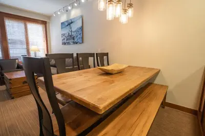 a dining room with a wooden table and chairs at The Village at Palisades Tahoe in Olympic Valley