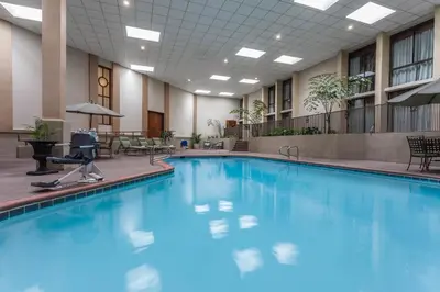 a large swimming pool in a hotel lobby at Wyndham Visalia in Visalia