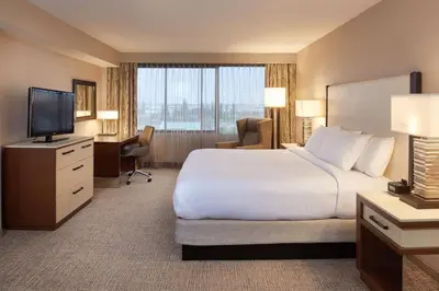 a hotel room with a large bed and a television at DoubleTree by Hilton Fresno Convention Center in Fresno