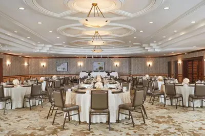 a banquet hall with tables and chairs and a chandelier at DoubleTree by Hilton Fresno Convention Center in Fresno