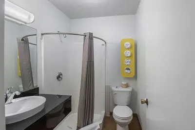 a bathroom with a white toilet and a sink at Motel 6-Fallon, NV in Fallon