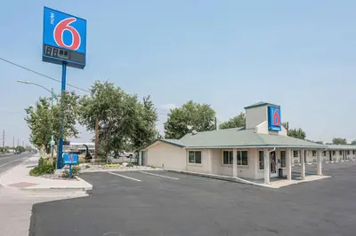 a gas station with a sign in a parking lot at Motel 6-Fallon, NV in Fallon