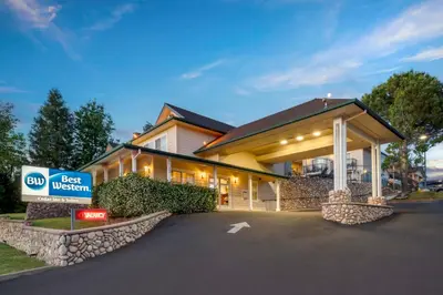 a best western inn with a sign in front of it at Best Western Cedar Inn & Suites in Angels Camp