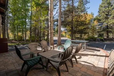 a patio with tables and chairs and trees at Inn At Truckee in Truckee