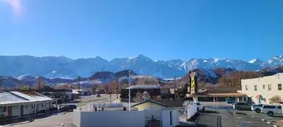 a small town with a mountain range in the background at Dow Villa Motel in Lone Pine