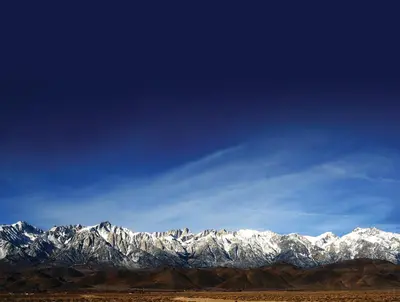a mountain range with snow covered mountains in the distance at Dow Villa Motel in Lone Pine