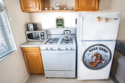 a white refrigerator in a kitchen with a stove at Mt Williamson Motel and Basecamp in Independence