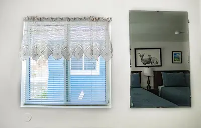 a window in a bedroom with a mirror at Mt Williamson Motel and Basecamp in Independence