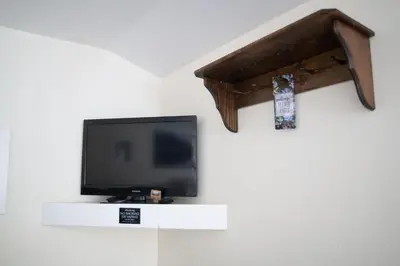 a flat screen tv sitting on a wall at Mt Williamson Motel and Basecamp in Independence