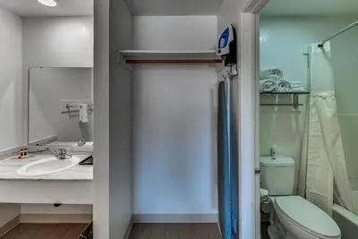 a bathroom with a toilet and a sink and a mirror at Angels Inn in Angels Camp
