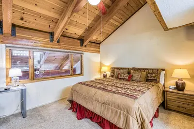 a bedroom with a large bed and a window at Courchevel 57 in Mammoth Lakes