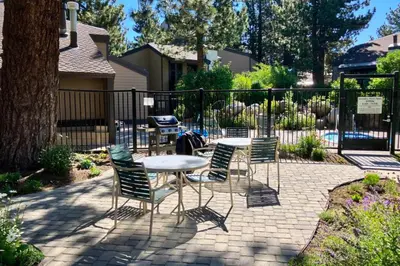 a patio with a table and chairs and a fence at Sherwin Villas 39 in Mammoth Lakes