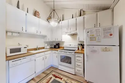 a kitchen with white appliances and white cabinets at Sherwin Villas 39 in Mammoth Lakes