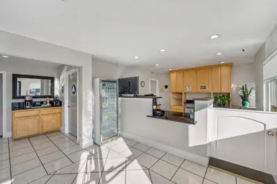 a kitchen with white appliances and wooden cabinets at Rodeway Inn Stockton Highway 99 in Stockton