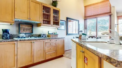 a kitchen with wooden cabinets and a sink at Snowcreek V #997 Condo in Mammoth Lakes