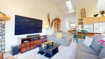 a living room with a large flat screen tv at Snowcreek V #997 Condo in Mammoth Lakes