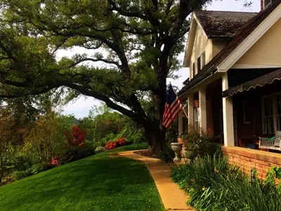a house with a tree with an american flag on it at The Inn on Knowles Hill Bed & Breakfast Hotel in Sonora