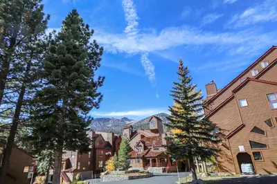 a town with trees and mountains in the background at Aspen Creek #306 Condo in Mammoth Lakes