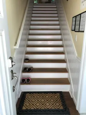 a set of stairs with shoes on the floor at Carriage House at Yosemite in Fish Camp