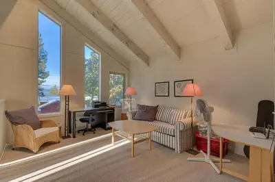 a living room with a couch and a desk at Sunny Daze at Dollar Point by Tahoe Getaways - Tahoe Classic w Open Floor Plan, Wood Fireplace, Close to Lake! in Tahoe City