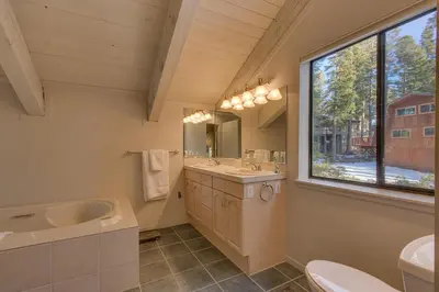 a bathroom with a sink toilet and a window at Sunny Daze at Dollar Point by Tahoe Getaways - Tahoe Classic w Open Floor Plan, Wood Fireplace, Close to Lake! in Tahoe City