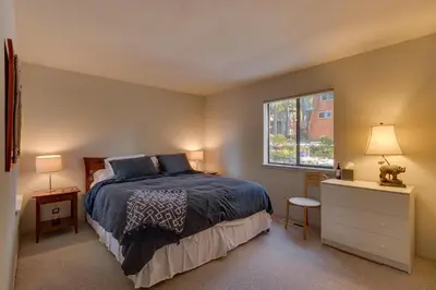 a bedroom with a bed and a window at Sunny Daze at Dollar Point by Tahoe Getaways - Tahoe Classic w Open Floor Plan, Wood Fireplace, Close to Lake! in Tahoe City
