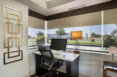 an office with a desk with a computer and a window at Best Western Big Country Inn in Coalinga