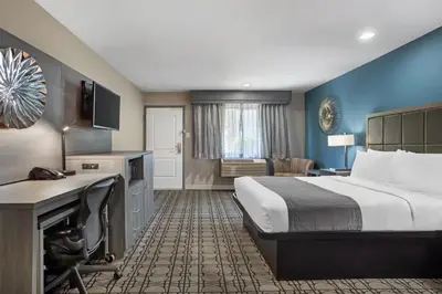 a hotel room with a large bed and a desk at Best Western Big Country Inn in Coalinga