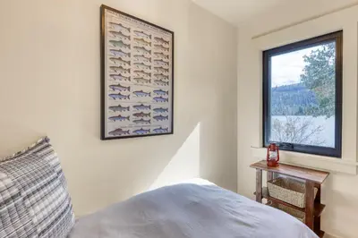 a bedroom with a picture of fish on the wall at Lake Front Family Home at Donner in Truckee