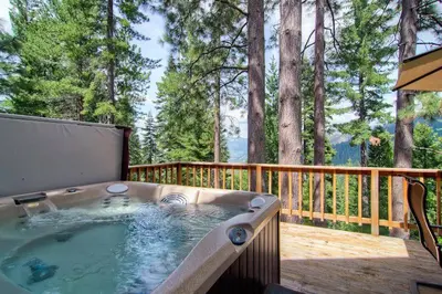 a hot tub on the deck of a house at Scenic Wonders & Apt. in Yosemite West