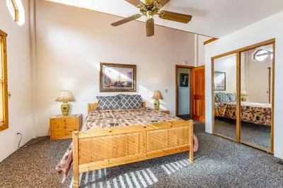 a bedroom with a bed and a ceiling fan at Scenic Wonders & Apt. in Yosemite West