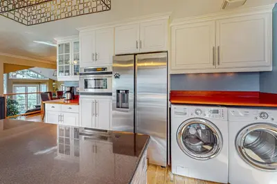 a kitchen with a refrigerator and a washer and dryer at The Lake Labyrinth in Zephyr Cove
