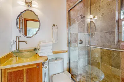 a bathroom with a shower and a toilet and a sink at The Lake Labyrinth in Zephyr Cove