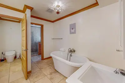 a bathroom with a bath tub and a toilet at The Lake Labyrinth in Zephyr Cove