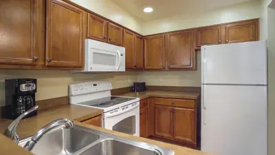 a kitchen with wooden cabinets and a white refrigerator at WorldMark South Shore in Zephyr Cove