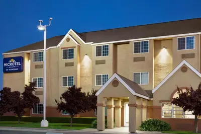 a large building with a sign in front of it at Microtel Inn & Suites Lodi in Lodi