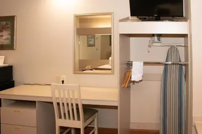 a room with a desk and a mirror at Microtel Inn & Suites Lodi in Lodi