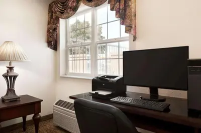an office with a desk with a computer and a window at Microtel Inn & Suites Lodi in Lodi
