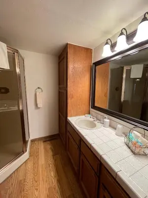 a bathroom with a sink and a mirror at Berkshire Inn in Groveland