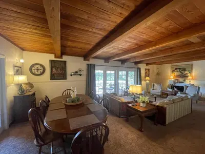 a living room with a table and a couch at Berkshire Inn in Groveland