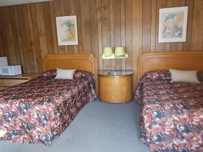 a hotel room with two beds and two lamps at Atomic Inn Beatty Near Death Valley in Beatty