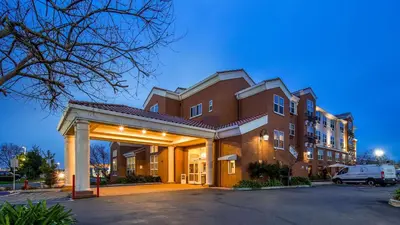 a large brick building with a parking lot at Best Western I-5 Inn & Suites in Lodi