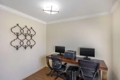 a room with a desk with two computers and chairs at Best Western Capital City Inn in Sacramento