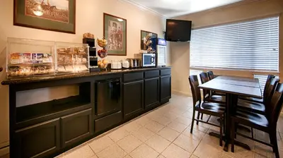a kitchen with a table and a dining room at Best Western Capital City Inn in Sacramento