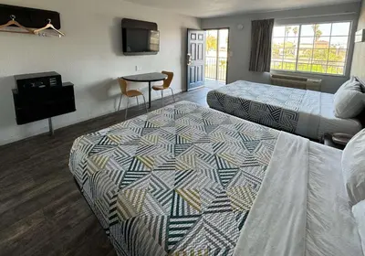 a hotel room with two beds and a television at Motel 6-Delano, CA in Delano