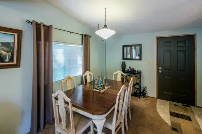 a dining room with a wooden table and chairs at Yosemite Cabin in Wawona