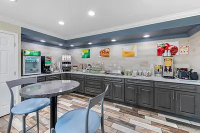 a large kitchen with a table and chairs at Quality Inn Kettleman City near Hwy 41 in Kettleman City