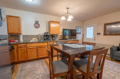 a kitchen with a wooden table and a dining room at Birch Creek #1 - 1BR/1BA - Down Canyon in June Lake