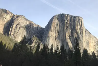 a large mountain with trees in front of it at McMillan Ranch Yosemite in Coarsegold